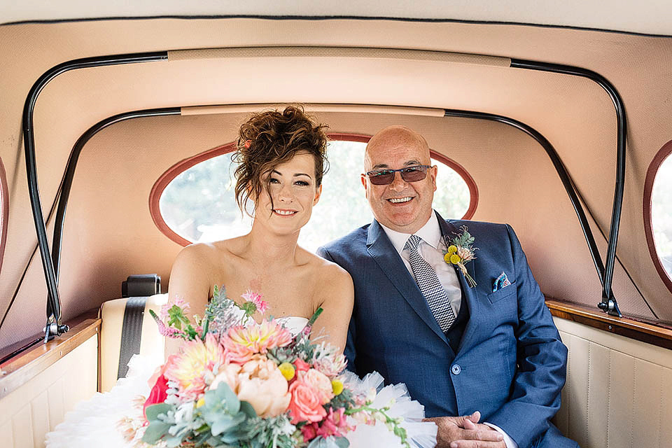 Audrey wore a 1950's inspired tiered wedding dress by Mooshki Bridal for her outdoor wedding in Scotland. The colourful and quirky wedding ceremony was held within the ruins of a chapel. Photography by Paul Joseph.