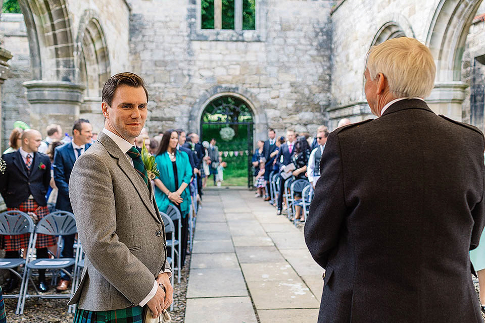 Audrey wore a 1950's inspired tiered wedding dress by Mooshki Bridal for her outdoor wedding in Scotland. The colourful and quirky wedding ceremony was held within the ruins of a chapel. Photography by Paul Joseph.