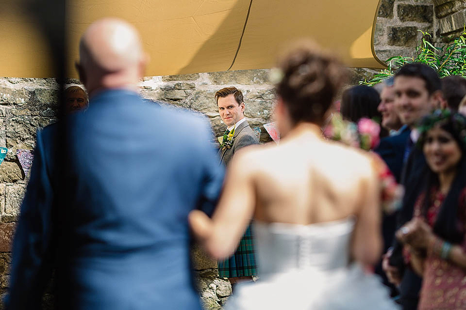 Audrey wore a 1950's inspired tiered wedding dress by Mooshki Bridal for her outdoor wedding in Scotland. The colourful and quirky wedding ceremony was held within the ruins of a chapel. Photography by Paul Joseph.