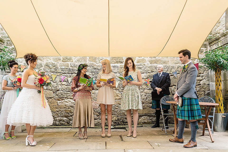 Audrey wore a 1950's inspired tiered wedding dress by Mooshki Bridal for her outdoor wedding in Scotland. The colourful and quirky wedding ceremony was held within the ruins of a chapel. Photography by Paul Joseph.