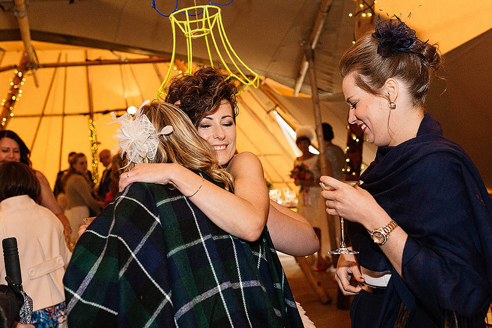 Audrey wore a 1950's inspired tiered wedding dress by Mooshki Bridal for her outdoor wedding in Scotland. The colourful and quirky wedding ceremony was held within the ruins of a chapel. Photography by Paul Joseph.