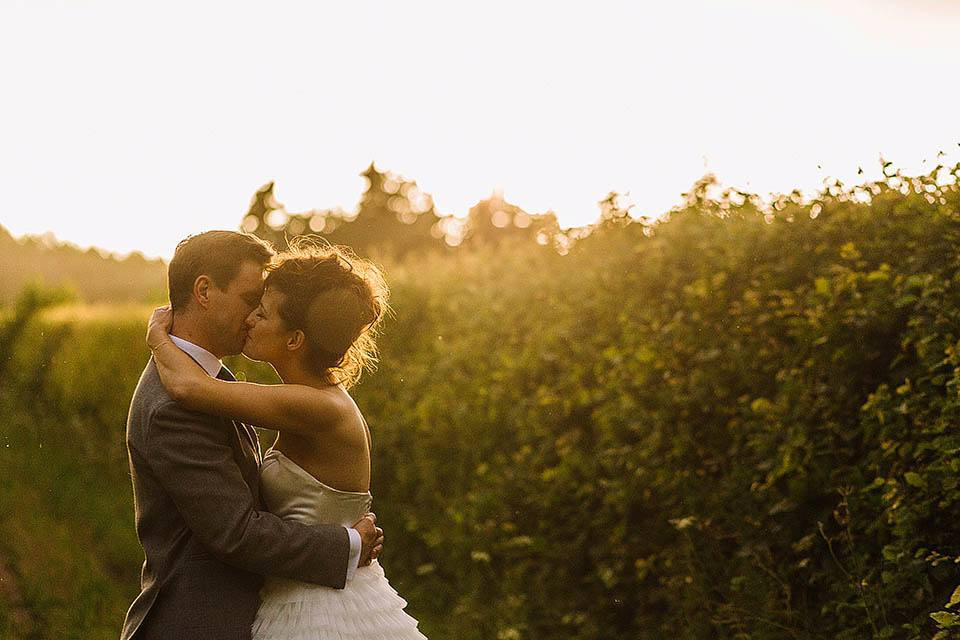 Audrey wore a 1950's inspired tiered wedding dress by Mooshki Bridal for her outdoor wedding in Scotland. The colourful and quirky wedding ceremony was held within the ruins of a chapel. Photography by Paul Joseph.