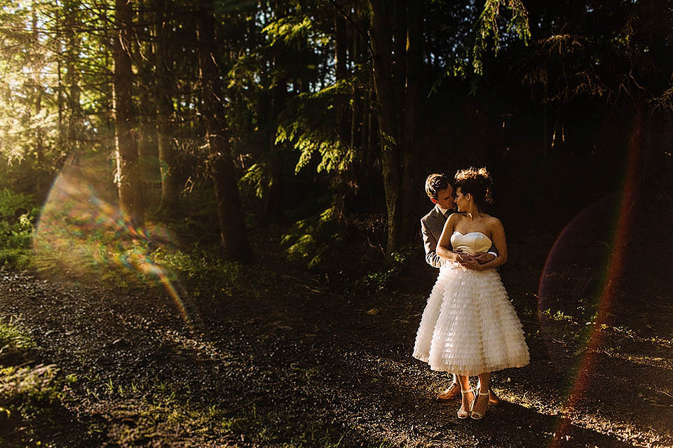 Audrey wore a 1950's inspired tiered wedding dress by Mooshki Bridal for her outdoor wedding in Scotland. The colourful and quirky wedding ceremony was held within the ruins of a chapel. Photography by Paul Joseph.