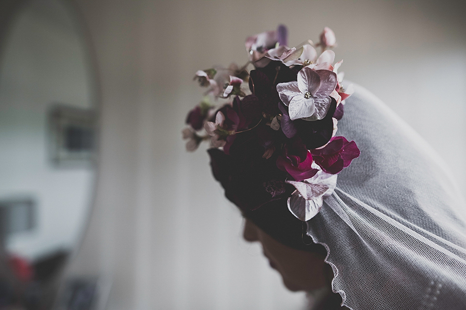 Tara wore a pleated dress in silk with a floral veil for her beautiful coastal wedding at Cushendall Golf Club in Northern Ireland. Photography by Mary McQuillan.