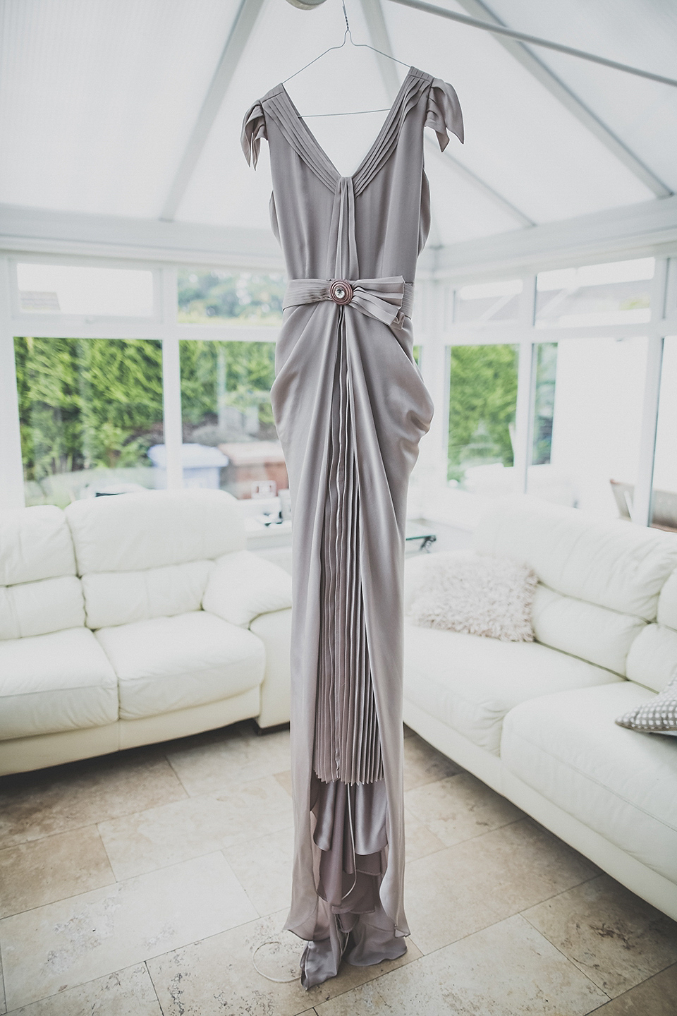 Tara wore a pleated dress in silk with a floral veil for her beautiful coastal wedding at Cushendall Golf Club in Northern Ireland. Photography by Mary McQuillan.