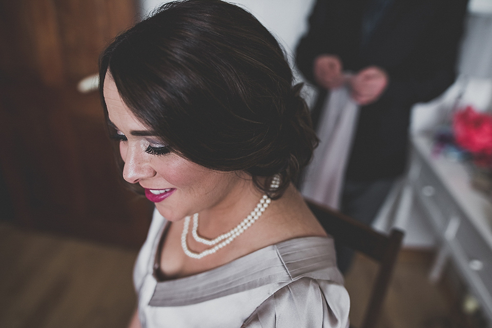 Tara wore a pleated dress in silk with a floral veil for her beautiful coastal wedding at Cushendall Golf Club in Northern Ireland. Photography by Mary McQuillan.