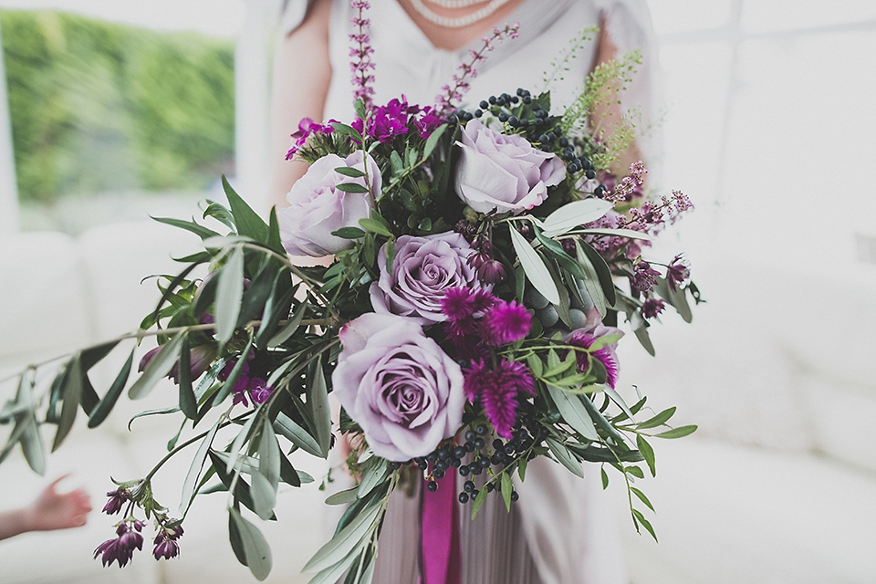 Tara wore a pleated dress in silk with a floral veil for her beautiful coastal wedding at Cushendall Golf Club in Northern Ireland. Photography by Mary McQuillan.