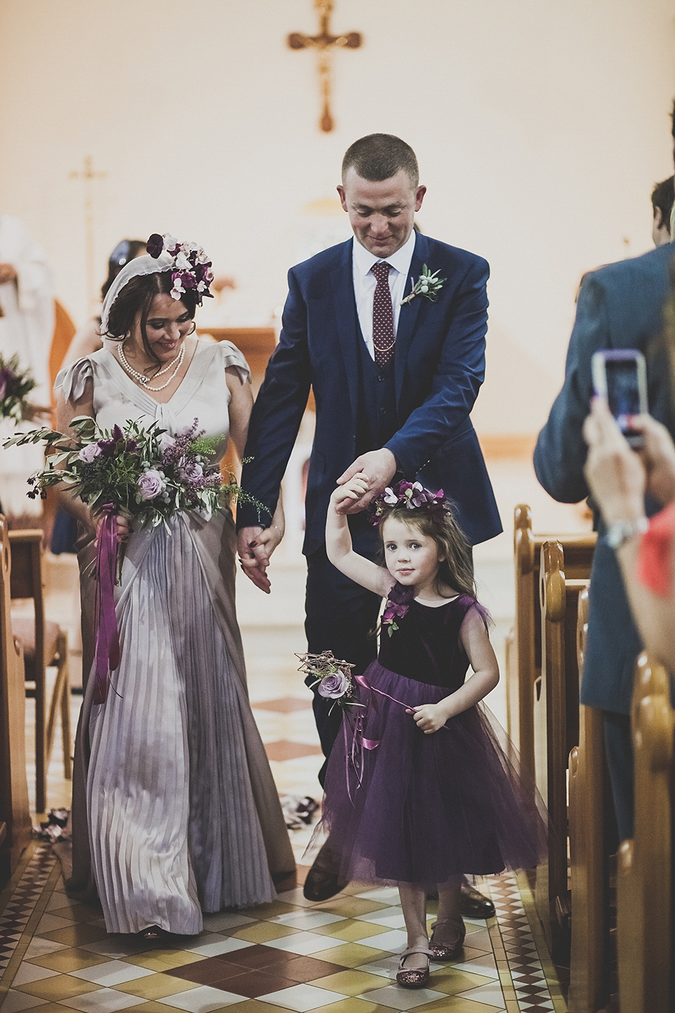 Tara wore a pleated dress in silk with a floral veil for her beautiful coastal wedding at Cushendall Golf Club in Northern Ireland. Photography by Mary McQuillan.