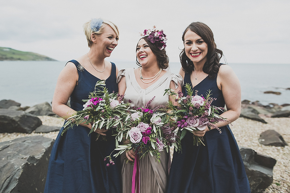 Tara wore a pleated dress in silk with a floral veil for her beautiful coastal wedding at Cushendall Golf Club in Northern Ireland. Photography by Mary McQuillan.