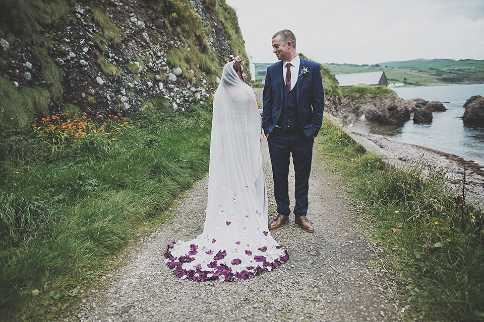 Tara wore a pleated dress in silk with a floral veil for her beautiful coastal wedding at Cushendall Golf Club in Northern Ireland. Photography by Mary McQuillan.