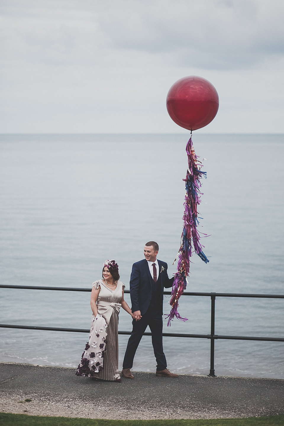 Tara wore a pleated dress in silk with a floral veil for her beautiful coastal wedding at Cushendall Golf Club in Northern Ireland. Photography by Mary McQuillan.