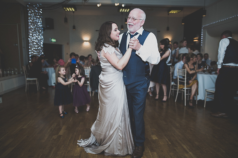 Tara wore a pleated dress in silk with a floral veil for her beautiful coastal wedding at Cushendall Golf Club in Northern Ireland. Photography by Mary McQuillan.