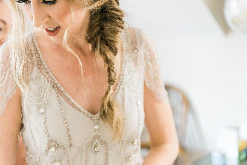 Bride Emma wore Eden by Jenny Packham, a fishtail plait and flowers in her hair for her ourdoor wedding at Baxby Manor. Photography by Sarah Folega.