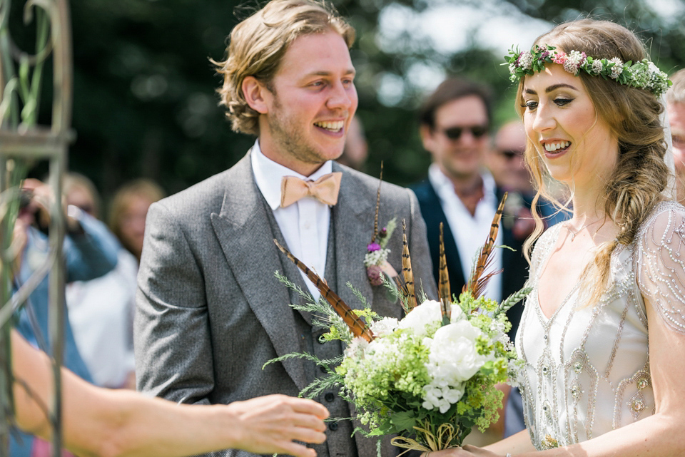 Bride Emma wore Eden by Jenny Packham, a fishtail plait and flowers in her hair for her ourdoor wedding at Baxby Manor. Photography by Sarah Folega.