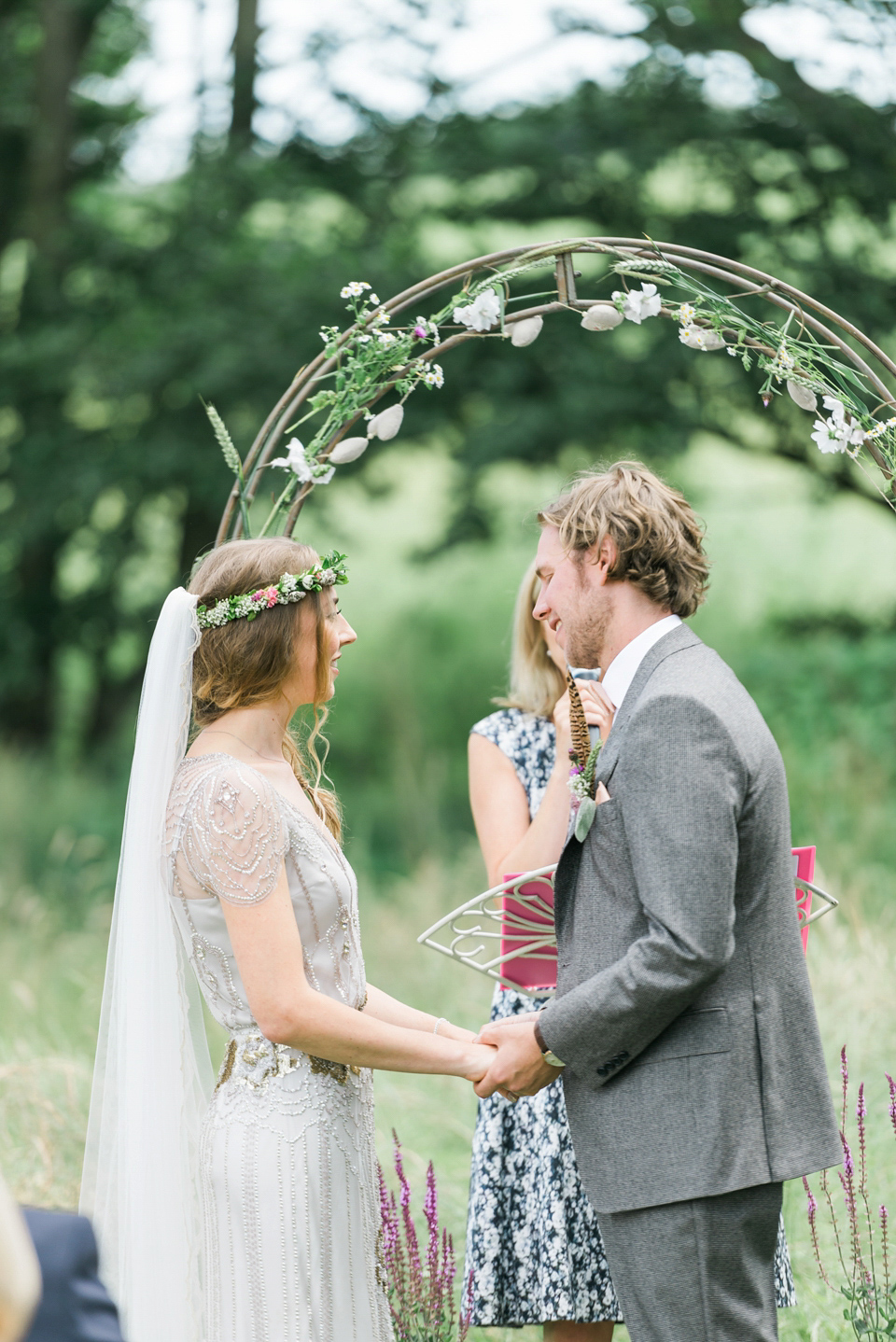 Bride Emma wore Eden by Jenny Packham, a fishtail plait and flowers in her hair for her ourdoor wedding at Baxby Manor. Photography by Sarah Folega.