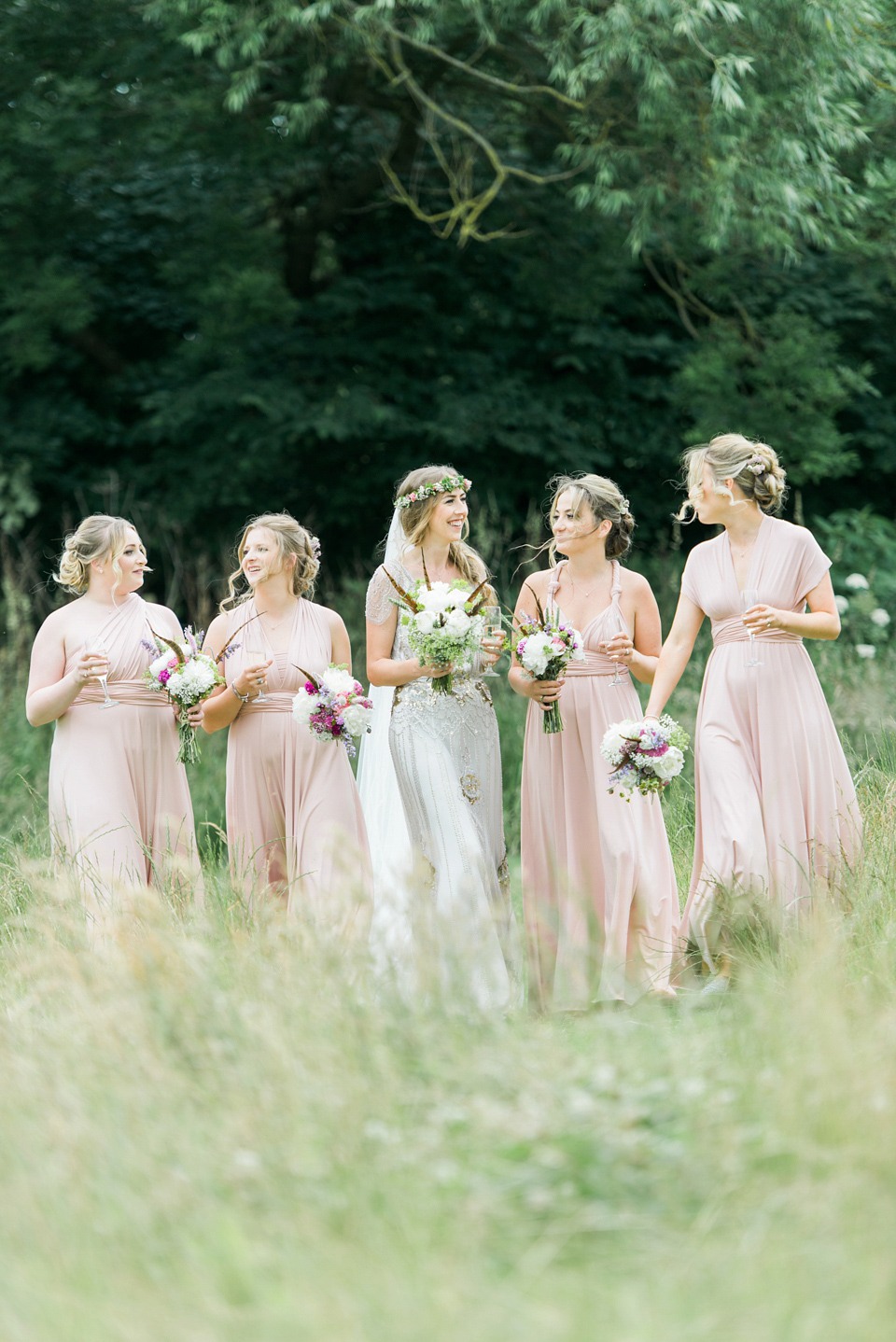 Bride Emma wore Eden by Jenny Packham, a fishtail plait and flowers in her hair for her ourdoor wedding at Baxby Manor. Photography by Sarah Folega.