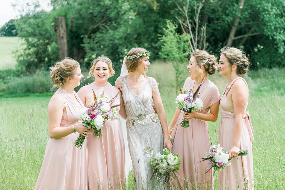 Bride Emma wore Eden by Jenny Packham, a fishtail plait and flowers in her hair for her ourdoor wedding at Baxby Manor. Photography by Sarah Folega.
