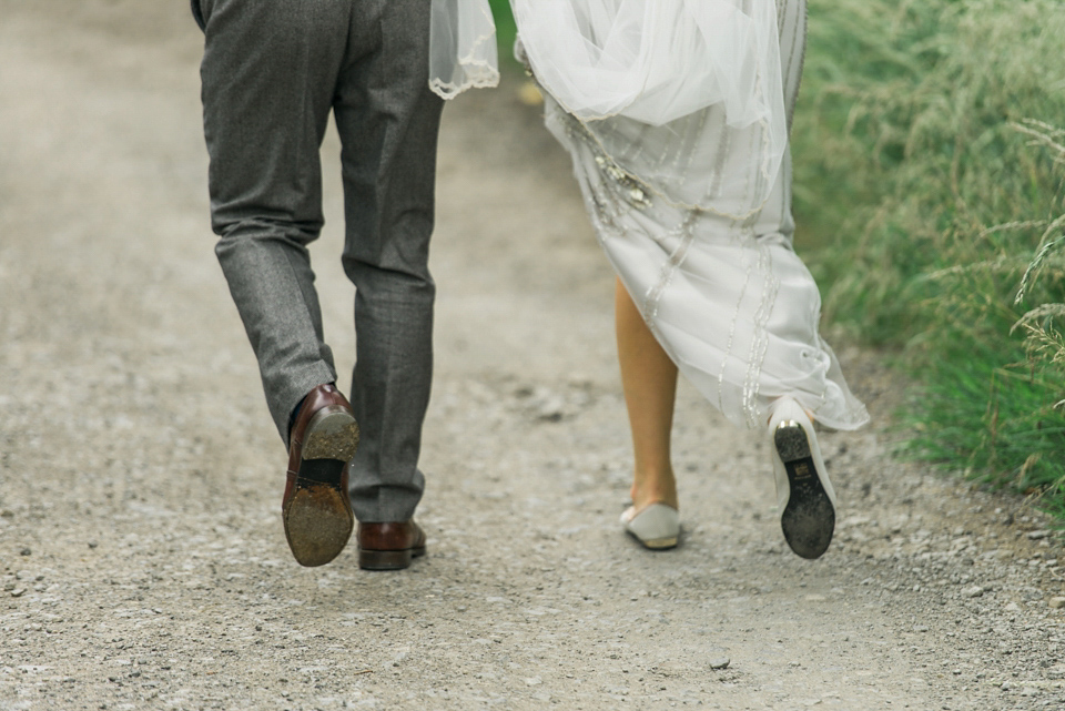 Bride Emma wore Eden by Jenny Packham, a fishtail plait and flowers in her hair for her ourdoor wedding at Baxby Manor. Photography by Sarah Folega.