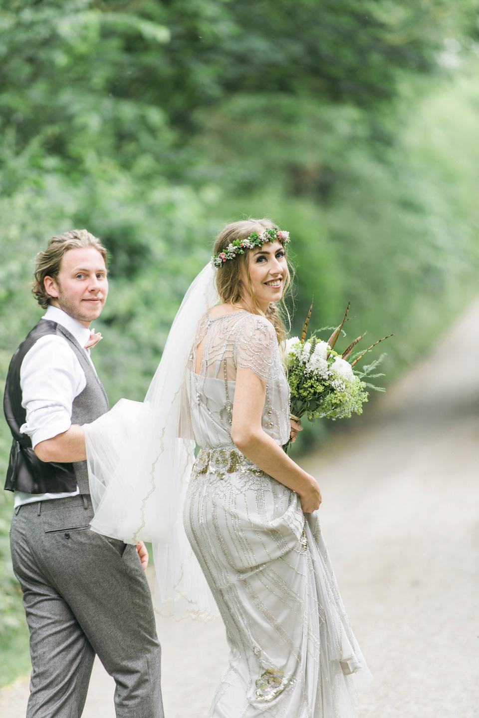 Bride Emma wore Eden by Jenny Packham, a fishtail plait and flowers in her hair for her ourdoor wedding at Baxby Manor. Photography by Sarah Folega.