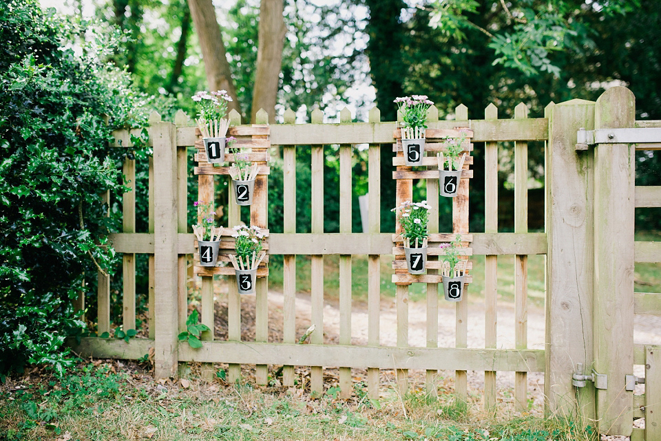 Kat wears Eden by Jenny Packham for her pretty Summer village hall wedding. Photography by Emma B.