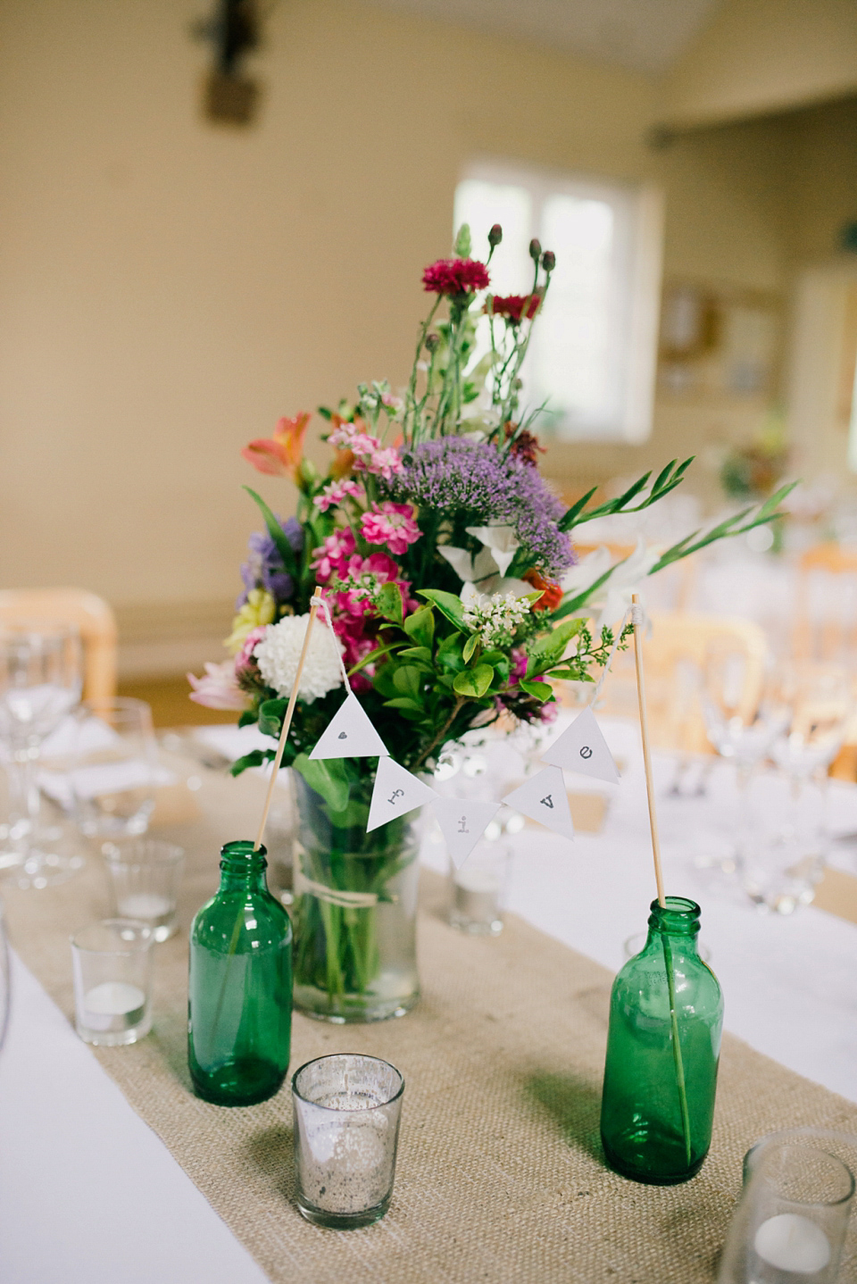 Kat wears Eden by Jenny Packham for her pretty Summer village hall wedding. Photography by Emma B.