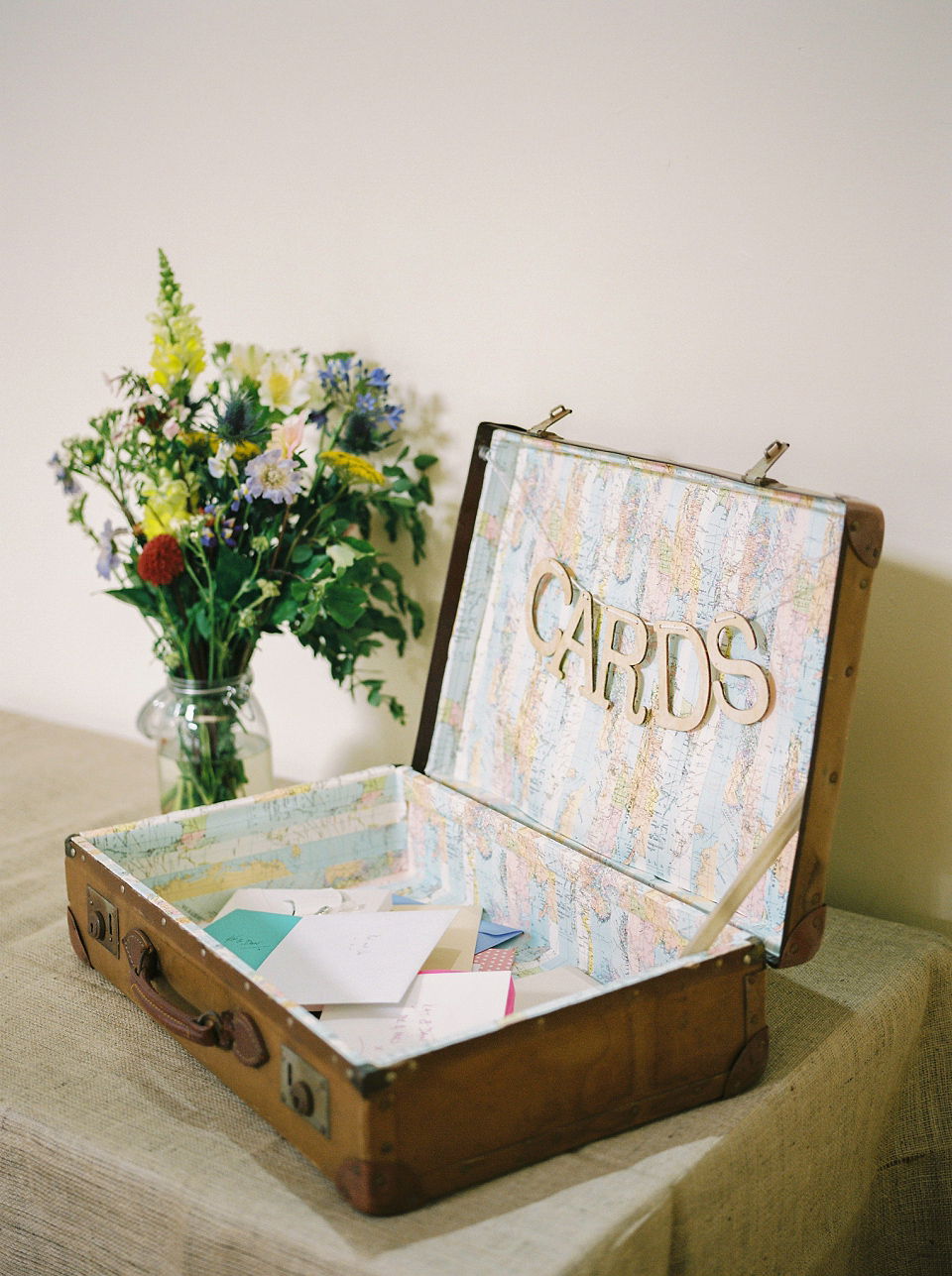 Kat wears Eden by Jenny Packham for her pretty Summer village hall wedding. Photography by Emma B.