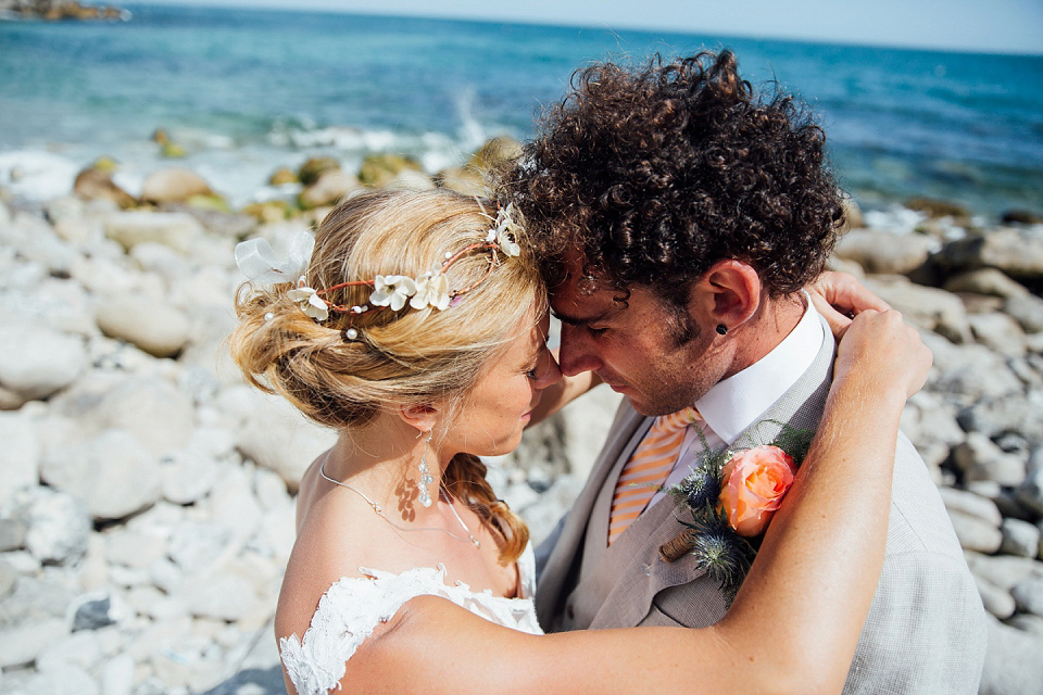 Bride Sarah wore an Essence of Australia gown and flowers in her hair for her wedding by the sea in Dorset. Photography by Charlotte Bryer Ash.