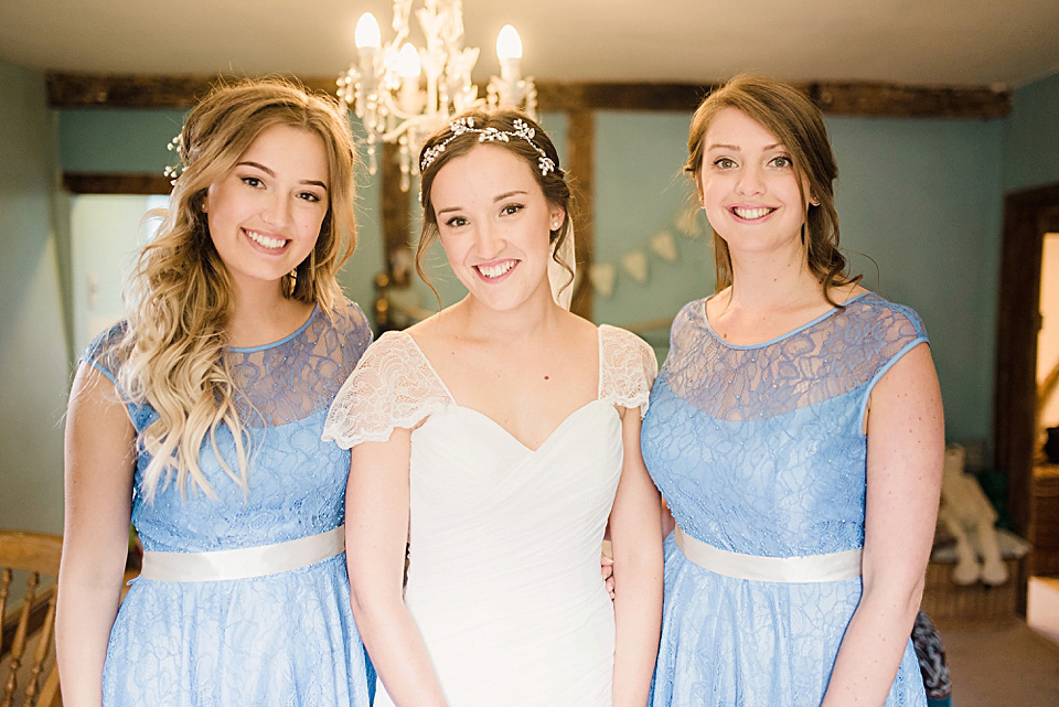 Bride Daisy wore a Stella York gown for her pale blue and flower filled Summer wedding in the English countryside. Photography by Faye Cornhill.