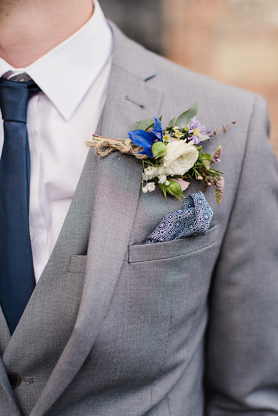 Bride Daisy wore a Stella York gown for her pale blue and flower filled Summer wedding in the English countryside. Photography by Faye Cornhill.