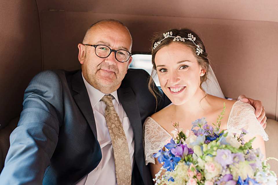 Bride Daisy wore a Stella York gown for her pale blue and flower filled Summer wedding in the English countryside. Photography by Faye Cornhill.