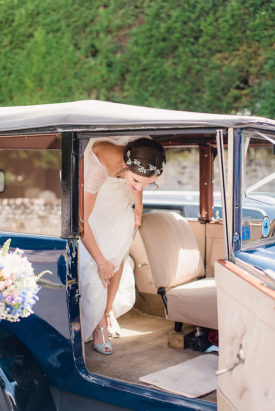 Bride Daisy wore a Stella York gown for her pale blue and flower filled Summer wedding in the English countryside. Photography by Faye Cornhill.