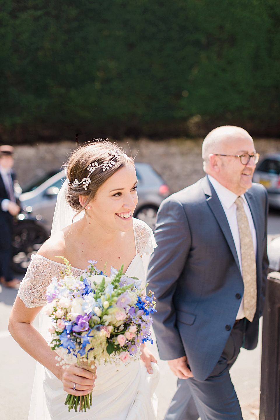 Bride Daisy wore a Stella York gown for her pale blue and flower filled Summer wedding in the English countryside. Photography by Faye Cornhill.