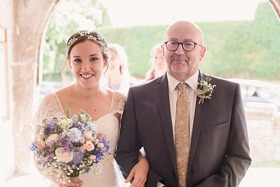 Bride Daisy wore a Stella York gown for her pale blue and flower filled Summer wedding in the English countryside. Photography by Faye Cornhill.