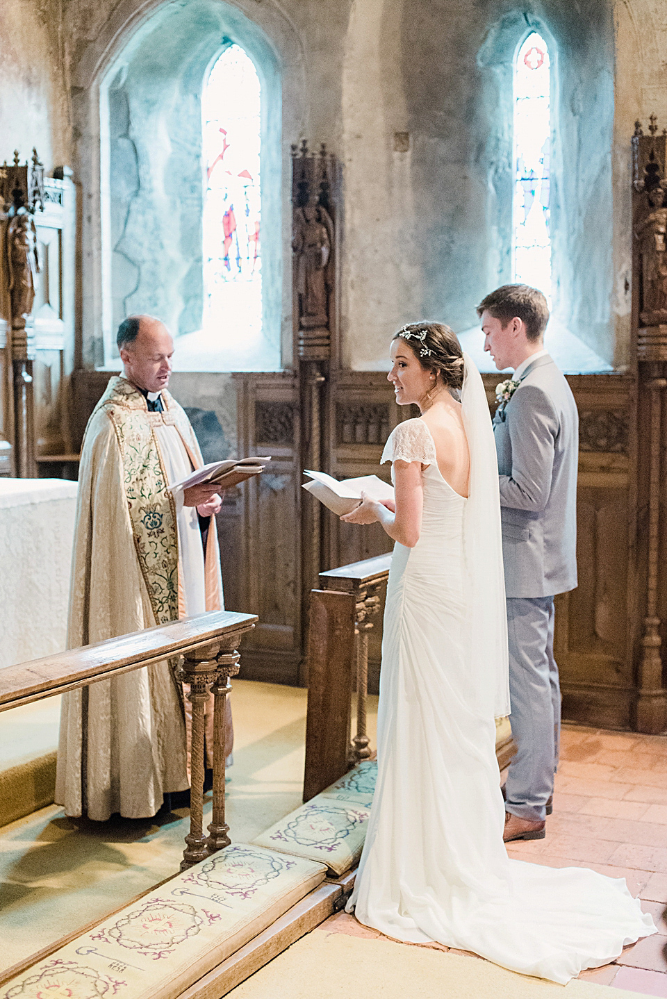 Bride Daisy wore a Stella York gown for her pale blue and flower filled Summer wedding in the English countryside. Photography by Faye Cornhill.