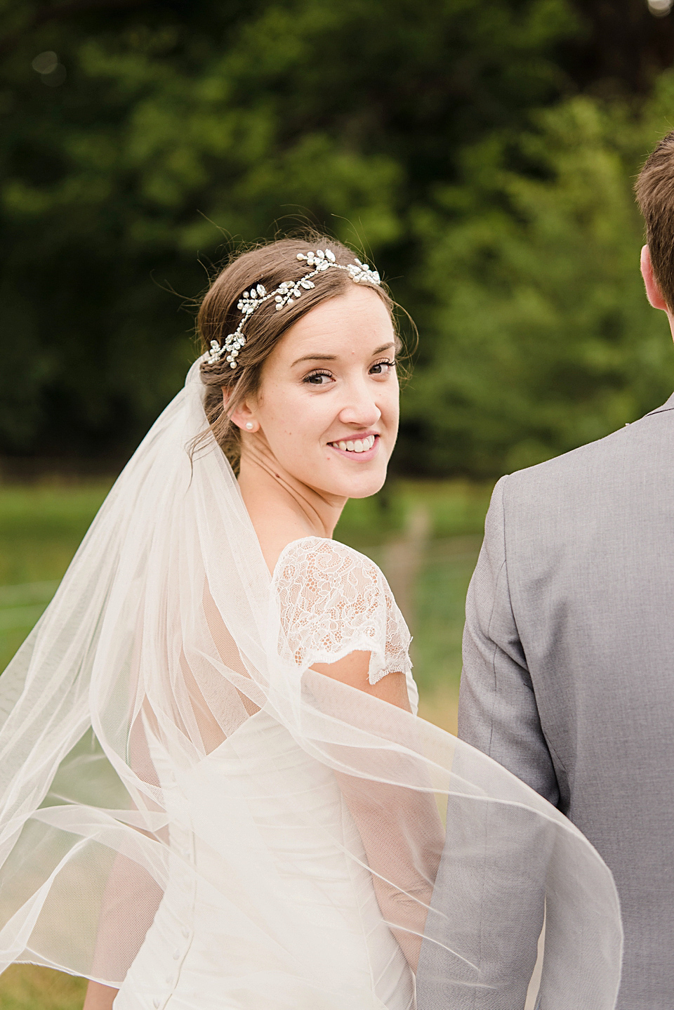 Bride Daisy wore a Stella York gown for her pale blue and flower filled Summer wedding in the English countryside. Photography by Faye Cornhill.