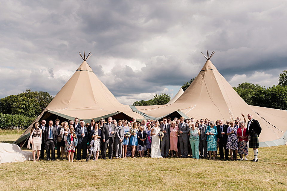 Bride Daisy wore a Stella York gown for her pale blue and flower filled Summer wedding in the English countryside. Photography by Faye Cornhill.