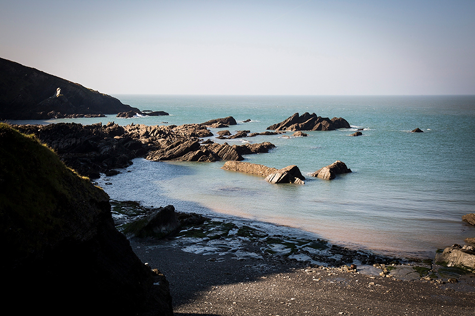 Bride Louisa wears a polka dot gown by Cathrine Deane for her seaside wedding in Devon.