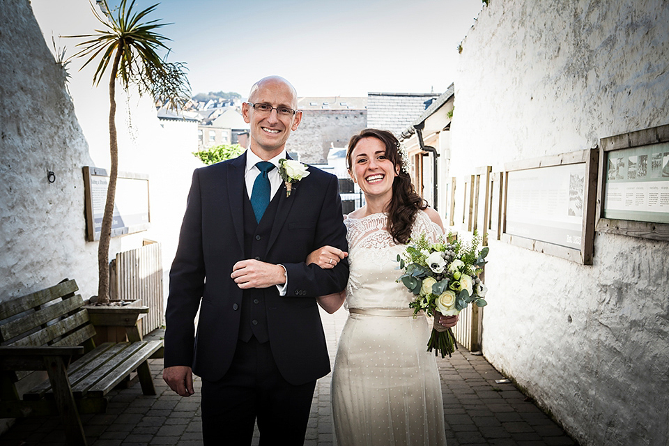 Bride Louisa wears a polka dot gown by Cathrine Deane for her seaside wedding in Devon.