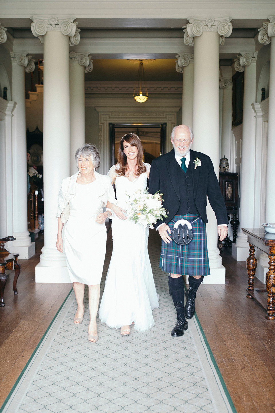 Bride Jenny wore a Rosa Clara wedding dress and a second shorter dress for dancing in at her pale green and botanical inspired wedding. Photography by Mirrorbox.