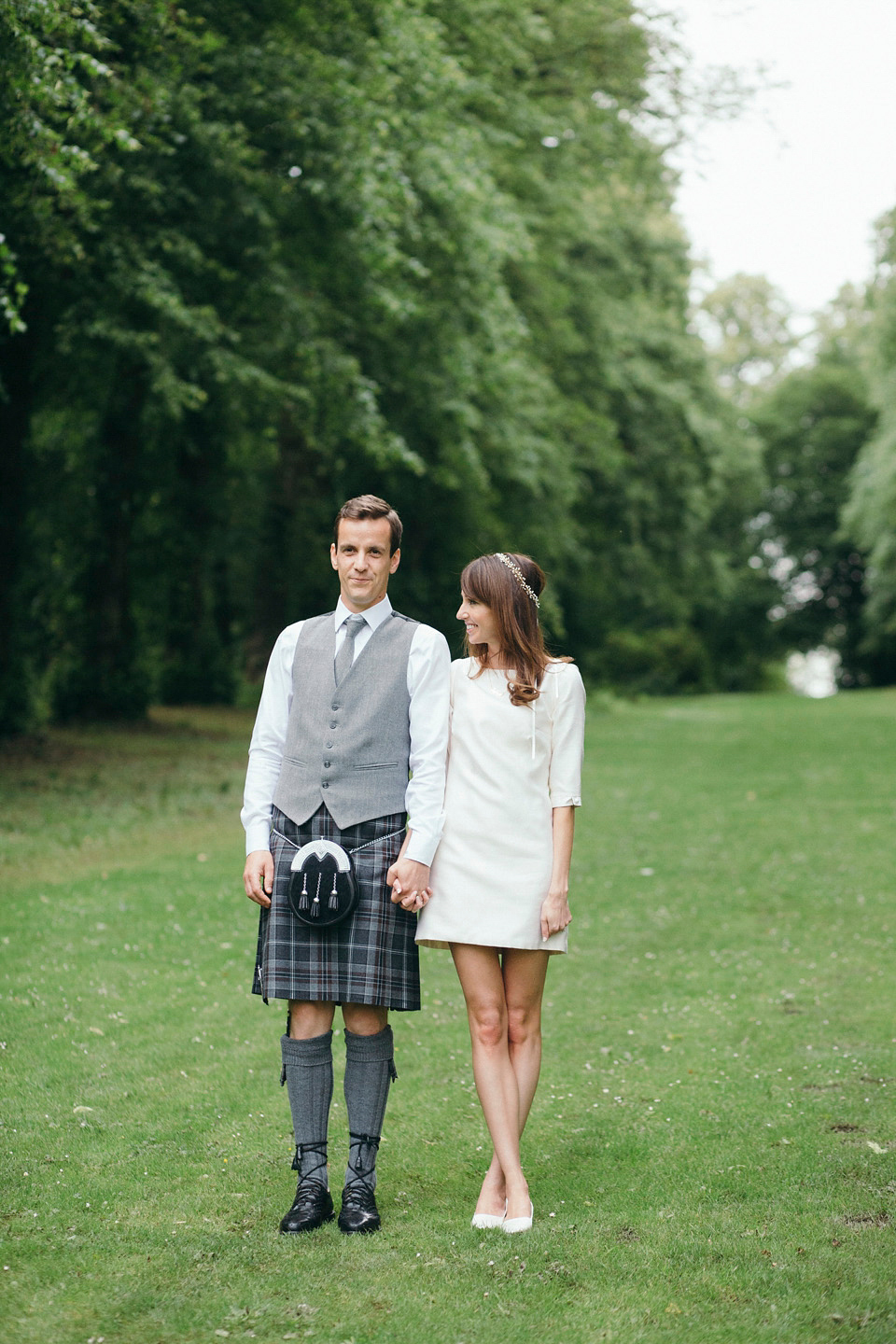 Bride Jenny wore a Rosa Clara wedding dress and a second shorter dress for dancing in at her pale green and botanical inspired wedding. Photography by Mirrorbox.