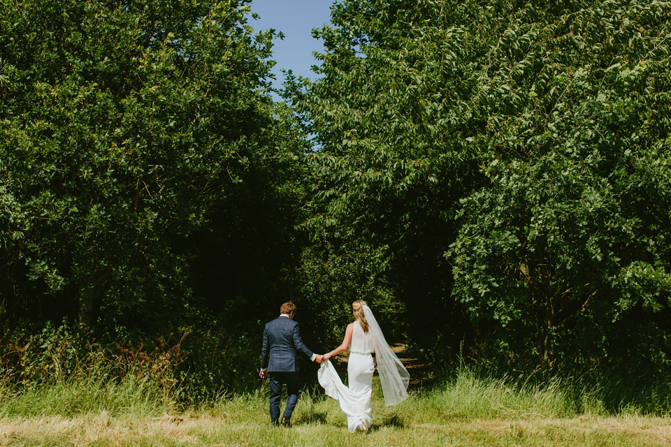 Alex wears a Pronovias gown for her English country barn wedding. Photography by Craig and Kate.