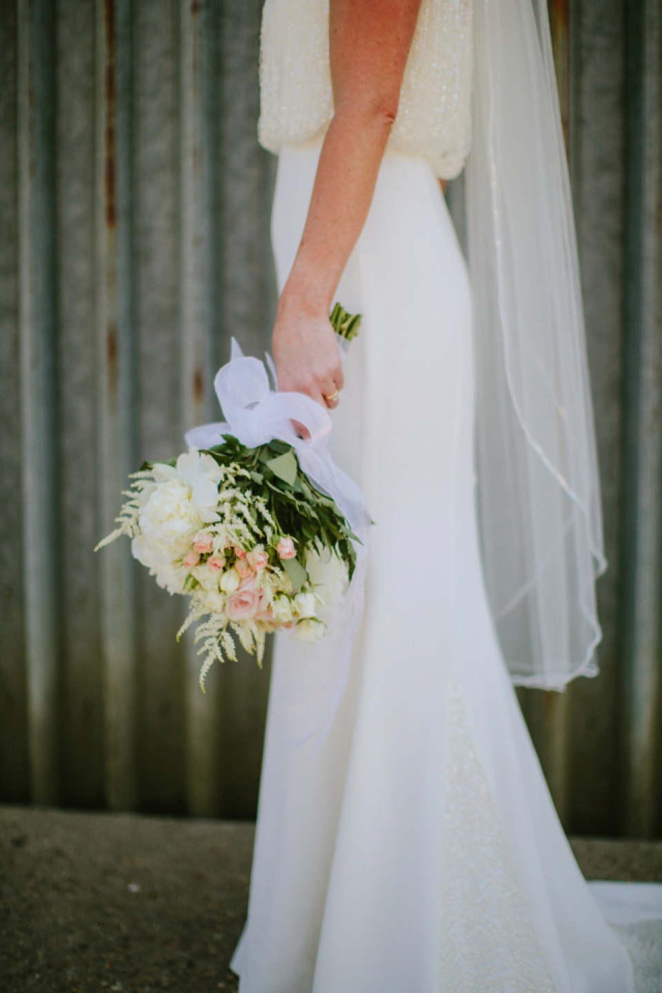 Alex wears a Pronovias gown for her English country barn wedding. Photography by Craig and Kate.