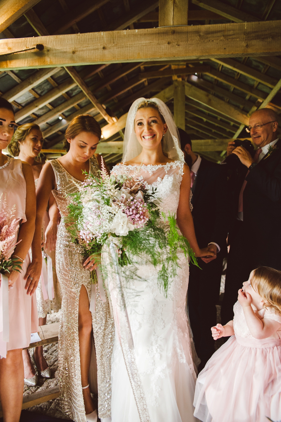 A joy filled barn wedding in shades of gold and pink, with a beautiful bride in a Stella York gown. Images by Mustard Yellow Photography.