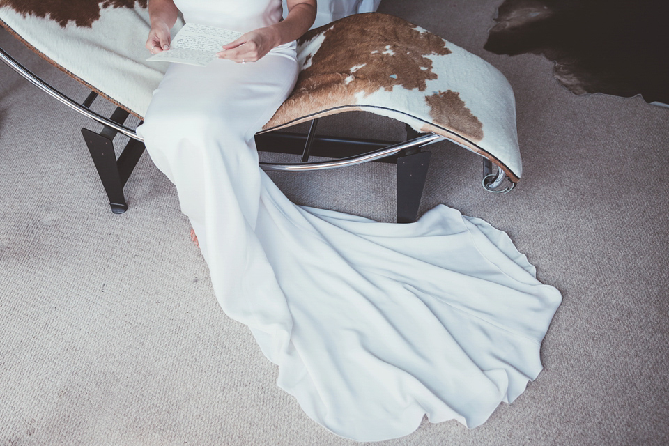 Charlotte wears a Charlotte Simpson gown for her wedding by the sea in Devon. Photography by Philippa James.