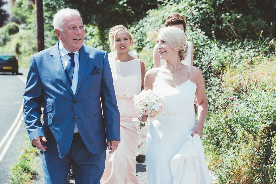 Charlotte wears a Charlotte Simpson gown for her wedding by the sea in Devon. Photography by Philippa James.