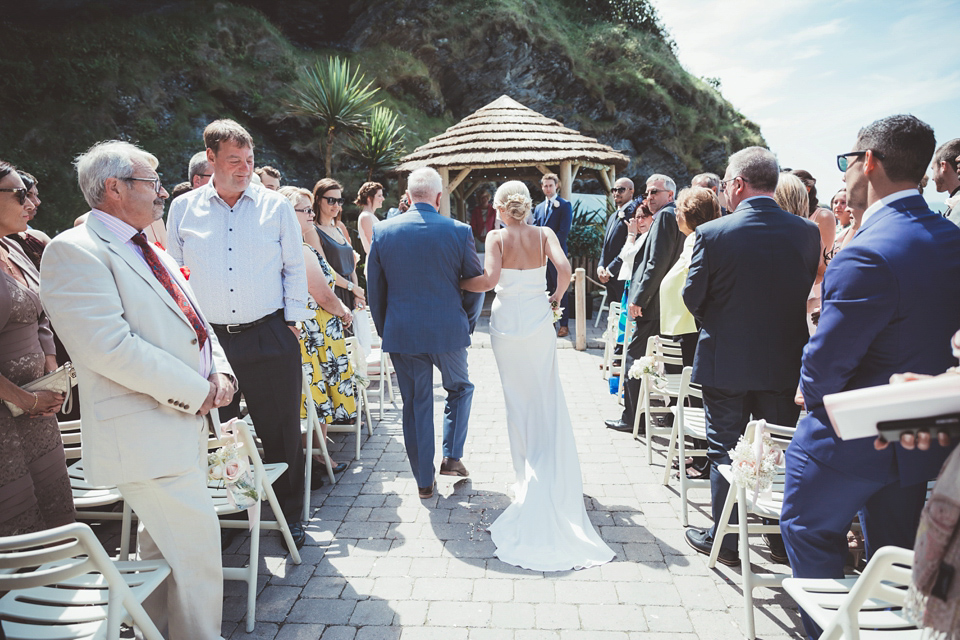 Charlotte wears a Charlotte Simpson gown for her wedding by the sea in Devon. Photography by Philippa James.