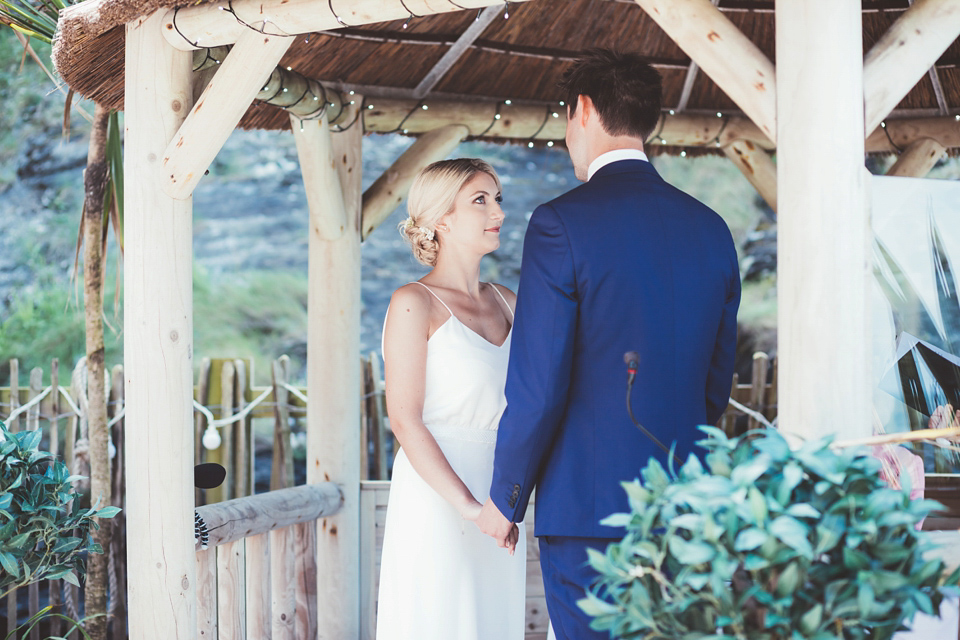 Charlotte wears a Charlotte Simpson gown for her wedding by the sea in Devon. Photography by Philippa James.