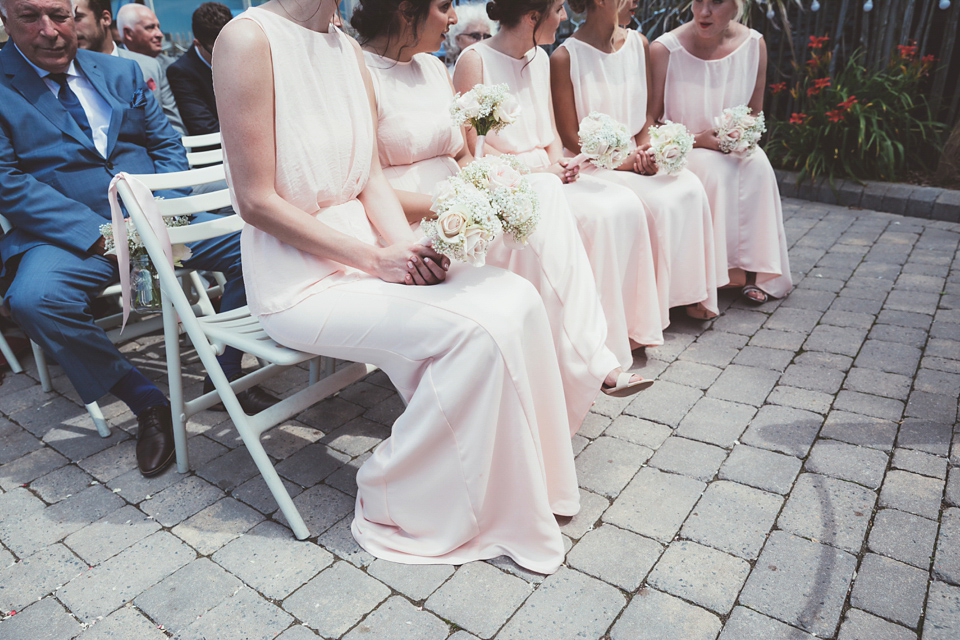 Charlotte wears a Charlotte Simpson gown for her wedding by the sea in Devon. Photography by Philippa James.