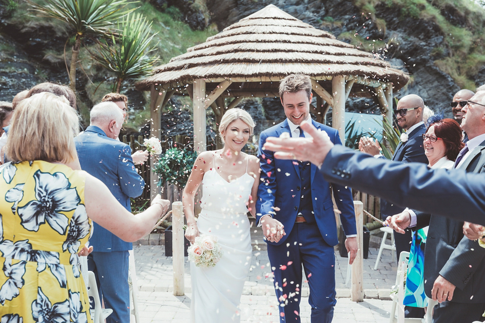 Charlotte wears a Charlotte Simpson gown for her wedding by the sea in Devon. Photography by Philippa James.