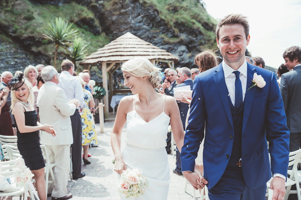 Charlotte wears a Charlotte Simpson gown for her wedding by the sea in Devon. Photography by Philippa James.